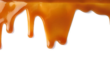 Stains of liquid caramel on white background