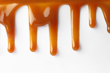 Stains of liquid caramel on white background