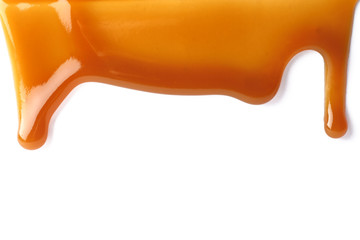 Stains of liquid caramel on white background