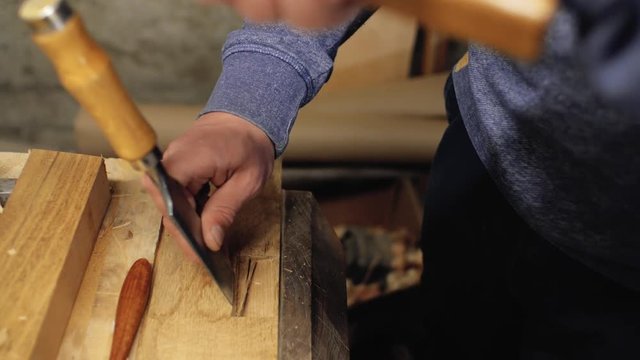 chisel in the hands of a professional carpenter. carpenter handles wooden plank carpentry tools.4k