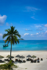 Beautiful tropical beach with pur white and blue sky and nobody or crowded tourist to fight for an inch of sun light
