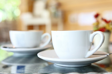 white cup of hot coffee drink put on table in cafe restaurant