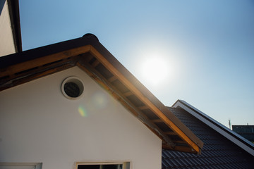 Tile Roof of a two-story white cottage