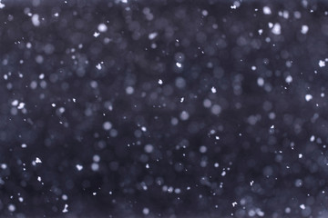 Falling snow down on the black background