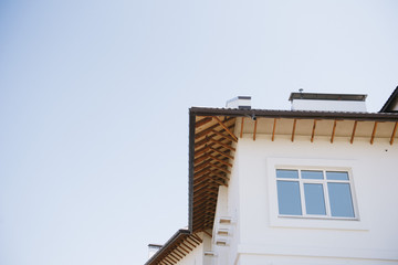 Tile Roof of a two-story white cottage