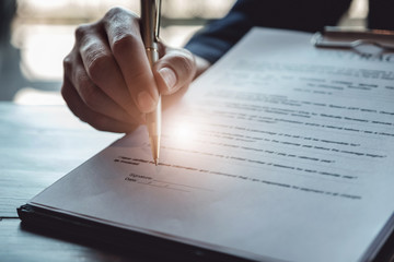 estate agent gives pen and documents agreement with customer to sign contract. Concept agreement