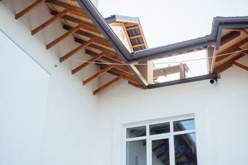 Tile Roof of a two-story white cottage