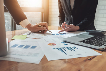 Economic business discussions, Business team analyzing income charts and graphs to plan marketing concept with using computer laptop and calculator for analysis.