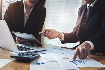 Economic research discussions, Business team analyzing income charts and graphs to plan marketing...