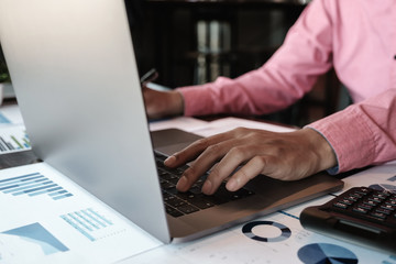 Stock marketing analysis concept, Male using computer laptop to analyze stock maket chart data...