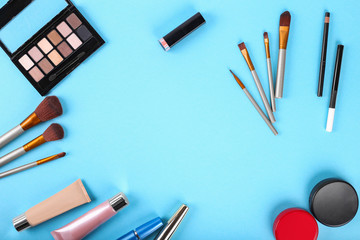 Flat lay.Palette of shadows and makeup brushes. Powder, concealer, highlighter, mascara, lipstick