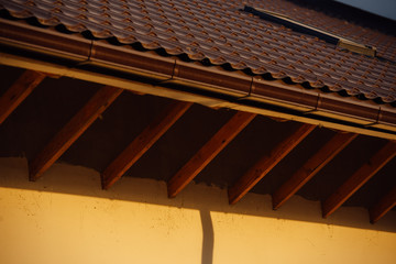 Obraz na płótnie Canvas Tile Roof of a two-story white cottage