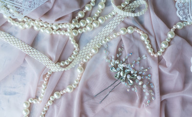 Wedding background with pearls and hair accessories on pink background