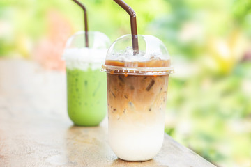 glasses of iced coffee latte and iced matcha green tea on wooden table 