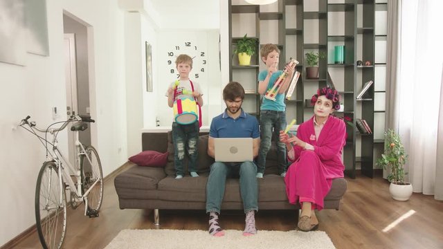 Modern Parents Looks After The Children At Home.