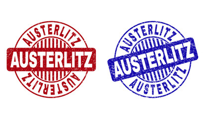 Grunge AUSTERLITZ round stamp seals isolated on a white background. Round seals with distress texture in red and blue colors. Vector rubber imitation of AUSTERLITZ tag inside circle form with stripes.