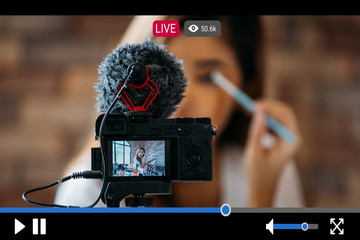 Young beautiful woman recording live stream video for makeup and cosmetics business purpose online...