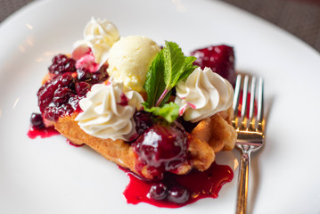 Belgian waffles with ice cream and berries
