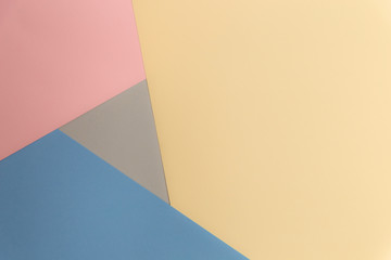Multicolor background from cardboard of different colors. Pastel paper color for background. Colorful abstract geometric shapes. Pastel colored paper texture minimalism background. Pink, Blue, Grey.