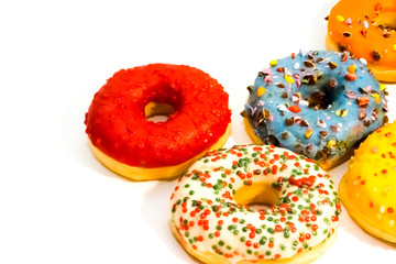 Sweet tasty donuts with colorful sprinkles isolated on white background