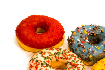 Sweet tasty donuts with colorful sprinkles isolated on white background