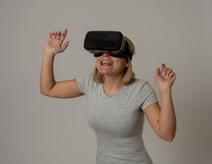 Portrait of cheerful and shocked young woman wearing Virtual Reality headset exploring 3D world