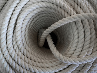 The thick rope twisted in a roll. The top view on a rope spiral. The rope curtailed into a circle
