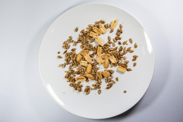 Mixed nuts in ceramic plate.Sunflower seeds snack ready to eat.