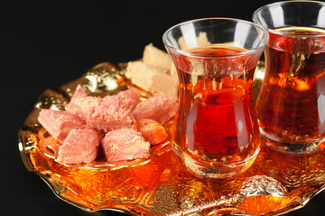Bowl with pieces of turkish delight lokum and black tea