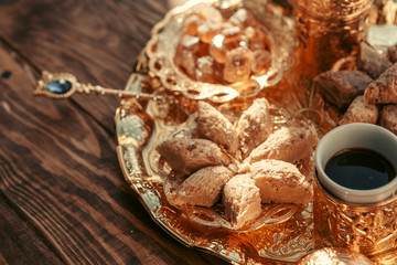 Turkish sweets with coffee on a wooden table