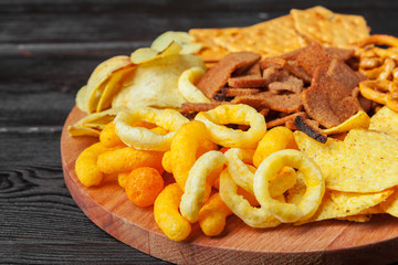 wide selection of snacks for beer on wooden background