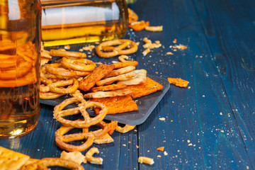 A selection of beer and snacks on wooden background