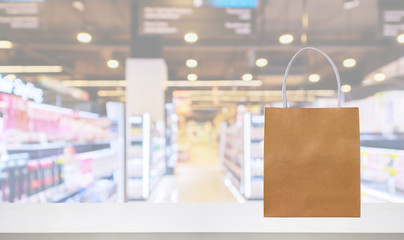 Paper bag on Pharmacy drugstore counter table with medicine and healthcare product on shelves blur background