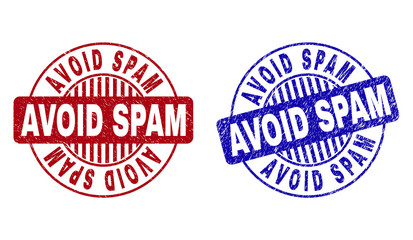 Grunge AVOID SPAM round stamp seals isolated on a white background. Round seals with grunge texture in red and blue colors. Vector rubber watermark of AVOID SPAM tag inside circle form with stripes.