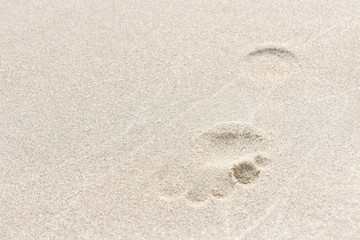 footprint in the sand. the concept of traveling to hot countries and relaxing on the beach.