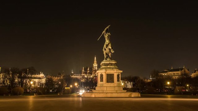 Moving timelapse / hyperlapse of Erzhercog Karl statue at night with Rathaus and Parliament in view