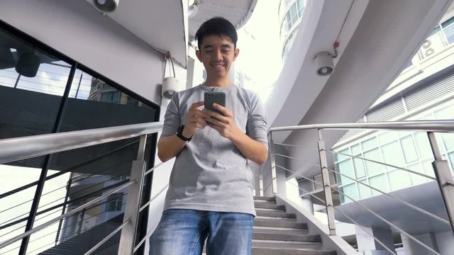 4K Asian man using smartphone on the stair, Modern life