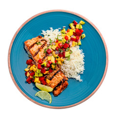 Salmon fillet cooked on grill with exotic sauce made of mango, avocado and pepper on blue plate. Studio shot above isolated on white background. Top view.