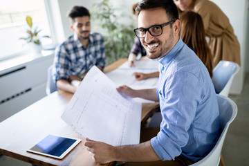 Young architects working on project in office