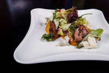 Appetizing salad sliced with pear slices of prosciutto pear arugula and parmesan