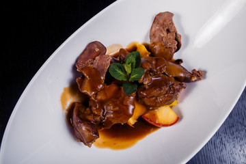 Duck liver with berry sauce and apples decorated with rosemary