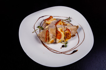 Spicy chicken fillet baked with bacon, tomatoes and cheddar cheese