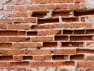 the old wall of red brick destroyed by wind and water