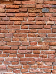 the old wall of red brick destroyed by wind and water