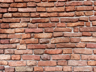 the old wall of red brick destroyed by wind and water