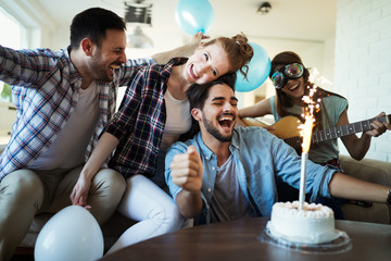 Cheerful young friends having fun on party
