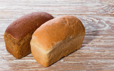 two breads on wooden background