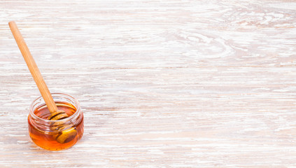 golden honey on wooden background