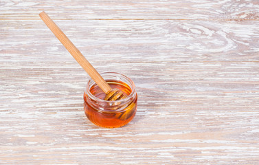 golden honey on wooden background