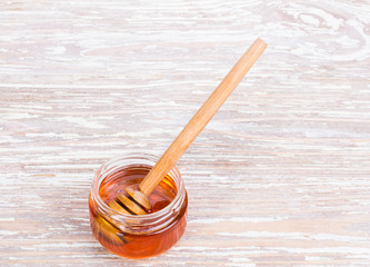 golden honey on wooden background